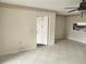 Bright living room featuring tile floors, a view of the kitchen, and neutral paint at 12119 Sunny Glen Ln # G2, Hudson, FL 34669