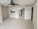 Cozy living room featuring tile floors, ceiling fan, and a kitchen view at 12119 Sunny Glen Ln # G2, Hudson, FL 34669