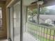 Screened-in patio with sliding glass doors, tile flooring, and outdoor views at 12119 Sunny Glen Ln # G2, Hudson, FL 34669