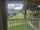 View from the screened-in patio of a grassy outdoor space at 12119 Sunny Glen Ln # G2, Hudson, FL 34669