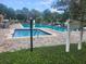 Community pool with sun loungers and lush greenery, offering a relaxing outdoor space at 12119 Sunny Glen Ln # G2, Hudson, FL 34669