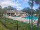 Community pool with lounge chairs provides a relaxing retreat surrounded by well-maintained landscaping at 12119 Sunny Glen Ln # G2, Hudson, FL 34669
