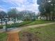 Community pool area behind a fence with lounging chairs and manicured landscaping at 12119 Sunny Glen Ln # G2, Hudson, FL 34669