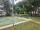 A shuffleboard court is surrounded by lush greenery with benches for relaxing between games at 12119 Sunny Glen Ln # G2, Hudson, FL 34669