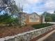 Stone and stucco sign for Pine Ridge at Sugar Creek community with manicured landscaping at 12119 Sunny Glen Ln # G2, Hudson, FL 34669