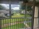 Screened patio with views of green landscaping and buildings in a well-maintained community at 12119 Sunny Glen Ln # G2, Hudson, FL 34669