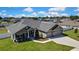 Wide aerial view of a single-Gathering home with a long driveway and a fenced backyard at 12848 Hilary St, Spring Hill, FL 34609