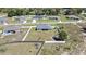 Aerial view of a home with a fenced yard, featuring a storage shed and playground in a residential neighborhood at 12848 Hilary St, Spring Hill, FL 34609