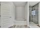 Bathroom featuring a separate tub, a shower with glass doors and neutral flooring at 12848 Hilary St, Spring Hill, FL 34609