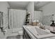 Bathroom features a shower/tub combo, granite countertop, storage ladder, and modern fixtures at 12848 Hilary St, Spring Hill, FL 34609