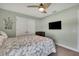 Bedroom featuring a neutral color scheme, double closet, ceiling fan, and a wall mounted TV at 12848 Hilary St, Spring Hill, FL 34609