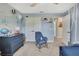 Bedroom features a dresser with decor, blue rocking chair and adjacent closet and doorway at 12848 Hilary St, Spring Hill, FL 34609