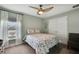 Bedroom features a neutral color scheme, double closet and a ceiling fan with lights at 12848 Hilary St, Spring Hill, FL 34609