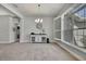 Dining room showcasing large windows, neutral paint, and elegant chandelier at 12848 Hilary St, Spring Hill, FL 34609