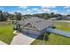 Aerial view of the home, featuring its three-car garage, neutral color scheme, and well-maintained landscaping at 12848 Hilary St, Spring Hill, FL 34609