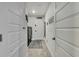 Hallway with laundry room featuring a side by side washer and dryer, and multiple doors at 12848 Hilary St, Spring Hill, FL 34609