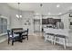 Eat-in kitchen features modern finishes, wood-look floors, stainless steel appliances, and counter stool seating at 12848 Hilary St, Spring Hill, FL 34609