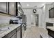 Well-lit kitchen featuring stainless steel appliances, wood flooring, and ample cabinet space at 12848 Hilary St, Spring Hill, FL 34609