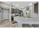 Modern kitchen boasts dark cabinets, granite counters, stainless appliances, and a practical breakfast bar at 12848 Hilary St, Spring Hill, FL 34609