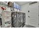 Well-organized laundry room featuring modern washer and dryer with ample storage solutions and shelving at 12848 Hilary St, Spring Hill, FL 34609