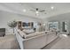 Spacious living room featuring a large sectional, built-in shelving, and ample natural light at 12848 Hilary St, Spring Hill, FL 34609