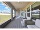 Comfortable screened-in lanai featuring cushioned wicker furniture and modern patterned rug at 12848 Hilary St, Spring Hill, FL 34609