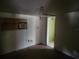 Image displays a small interior bedroom with exposed wires, peeling paint, and an outdated window air conditioning unit at 13120 Davista Ave, New Port Richey, FL 34654