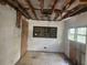 A bedroom interior requiring extensive repairs showcases damaged walls, floor, and ceiling at 13120 Davista Ave, New Port Richey, FL 34654