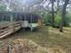 View of the home's exterior showing the side porch and surrounding greenery at 13120 Davista Ave, New Port Richey, FL 34654