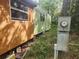 Side view of the property with wood siding, green trim and electric meter at 13120 Davista Ave, New Port Richey, FL 34654