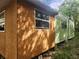 Dilapidated mobile home featuring weathered wood and green panels with several double hung windows at 13120 Davista Ave, New Port Richey, FL 34654