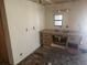 Unfinished kitchen area featuring a sink and bare walls awaiting restoration at 13120 Davista Ave, New Port Richey, FL 34654