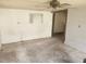 An unfinished living room with outdated walls and floors awaiting renovation at 13120 Davista Ave, New Port Richey, FL 34654