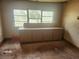 Unfinished living room featuring a bank of windows and built-in cabinetry at 13120 Davista Ave, New Port Richey, FL 34654