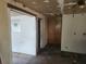 An unfurnished living room featuring an outdated design and bare walls and floors ready for renovation at 13120 Davista Ave, New Port Richey, FL 34654