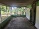 A view of the screened-in porch with an entry door and outdoor view at 13120 Davista Ave, New Port Richey, FL 34654
