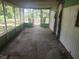 Screened-in porch with bare floor, overlooking a grassy yard at 13120 Davista Ave, New Port Richey, FL 34654