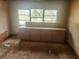 Unfinished room, showing a built-in cabinet and dirty floors ready for refurbishment at 13120 Davista Ave, New Port Richey, FL 34654