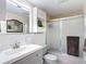 Updated bathroom featuring a vanity with a mirror, toilet, and tile shower at 13415 Starfish Dr, Hudson, FL 34667