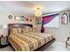 Cozy primary bedroom with a decorative lamp and a Queen-size bed at 13415 Starfish Dr, Hudson, FL 34667