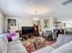 Comfortable living room featuring a vibrant rug, neutral walls, and an open view to the kitchen at 13415 Starfish Dr, Hudson, FL 34667