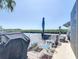 Outdoor patio area with grilling area and table overlooking the canal, perfect for relaxing and enjoying waterfront views at 13415 Starfish Dr, Hudson, FL 34667
