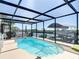 Beautiful enclosed pool overlooking the canal and boat dock, perfect for relaxing and enjoying waterfront living at 13415 Starfish Dr, Hudson, FL 34667