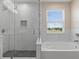 This bathroom has a glass shower and a garden tub at 13619 Hunters Point St, Spring Hill, FL 34609