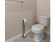 Bathroom featuring a decorative toilet paper holder and toilet at 13619 Hunters Point St, Spring Hill, FL 34609