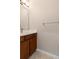 Bathroom featuring a vanity with dark wood cabinets, decorative mirror at 13619 Hunters Point St, Spring Hill, FL 34609