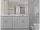 A bathroom featuring double vanity and glass enclosed shower at 13619 Hunters Point St, Spring Hill, FL 34609