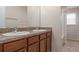 Bathroom featuring a double sink vanity with warm-toned cabinetry at 13619 Hunters Point St, Spring Hill, FL 34609