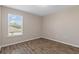 Well-lit bedroom features wood-look flooring, a bright window with blinds, and neutral walls at 13619 Hunters Point St, Spring Hill, FL 34609