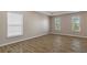 A secondary bedroom with wood-look floors and a bright window at 13619 Hunters Point St, Spring Hill, FL 34609
